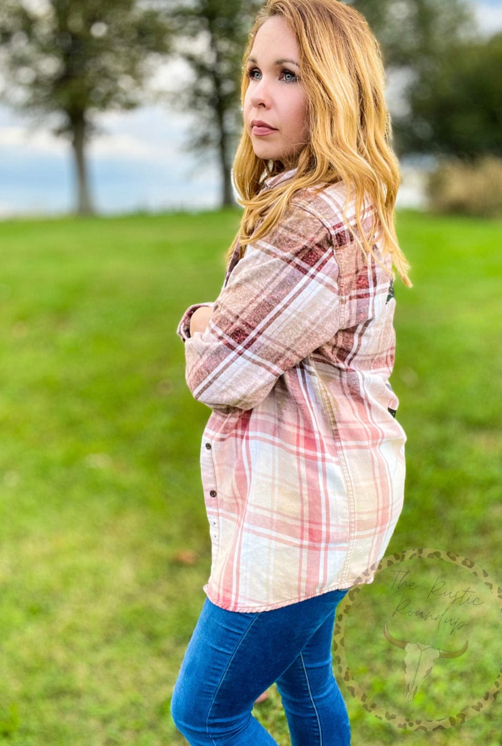 Midsize woman outdoors wearing bleached flannel with Yellowstone, influencer style, ootd